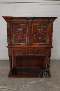 картинка Антикварный поставец с фасадом в виде сложного растительного орнамента и мифологических фигур салоне старинных вещей "Шебби" являющийся официальным дистрибьютором в России и Беларуси