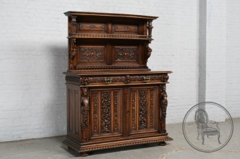 Антикварный ореховый буфет с плотной резьбой в мифологической тематике, декорированный резными барельефами код. BE107581